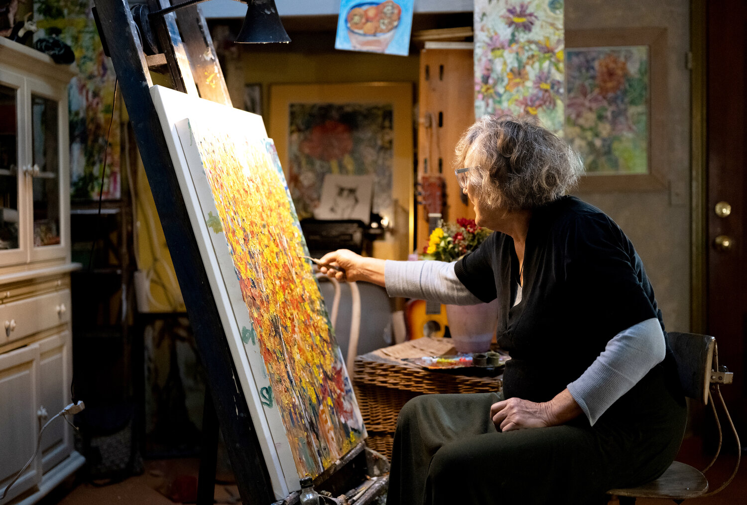 Tweed Meyer works on an oil painting inspired by the colors of autumn.